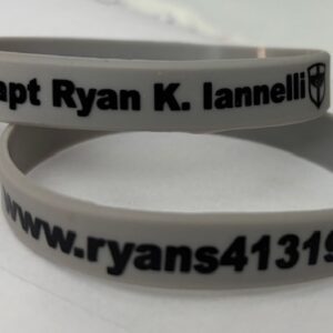 A white wristband with the words " capt ryan k. Lannelli www. Rans 4 1 3 1 9."